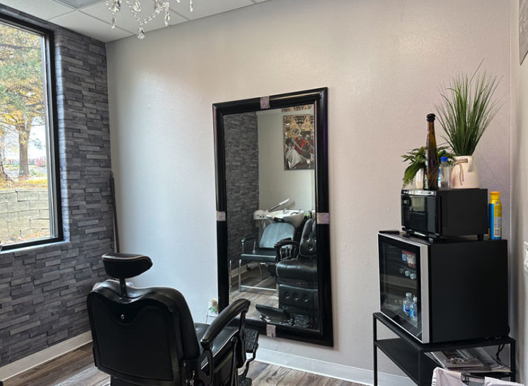 Barber chair facing a full-length mirror in Joni's suite at Spectra Salon Suites