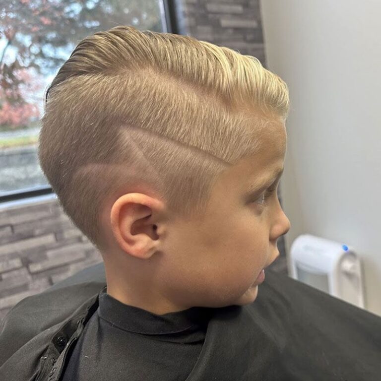 Boy's haircut with a hard part line and short tapered sides at Joni's Gentleman's Cuts, Lone Tree