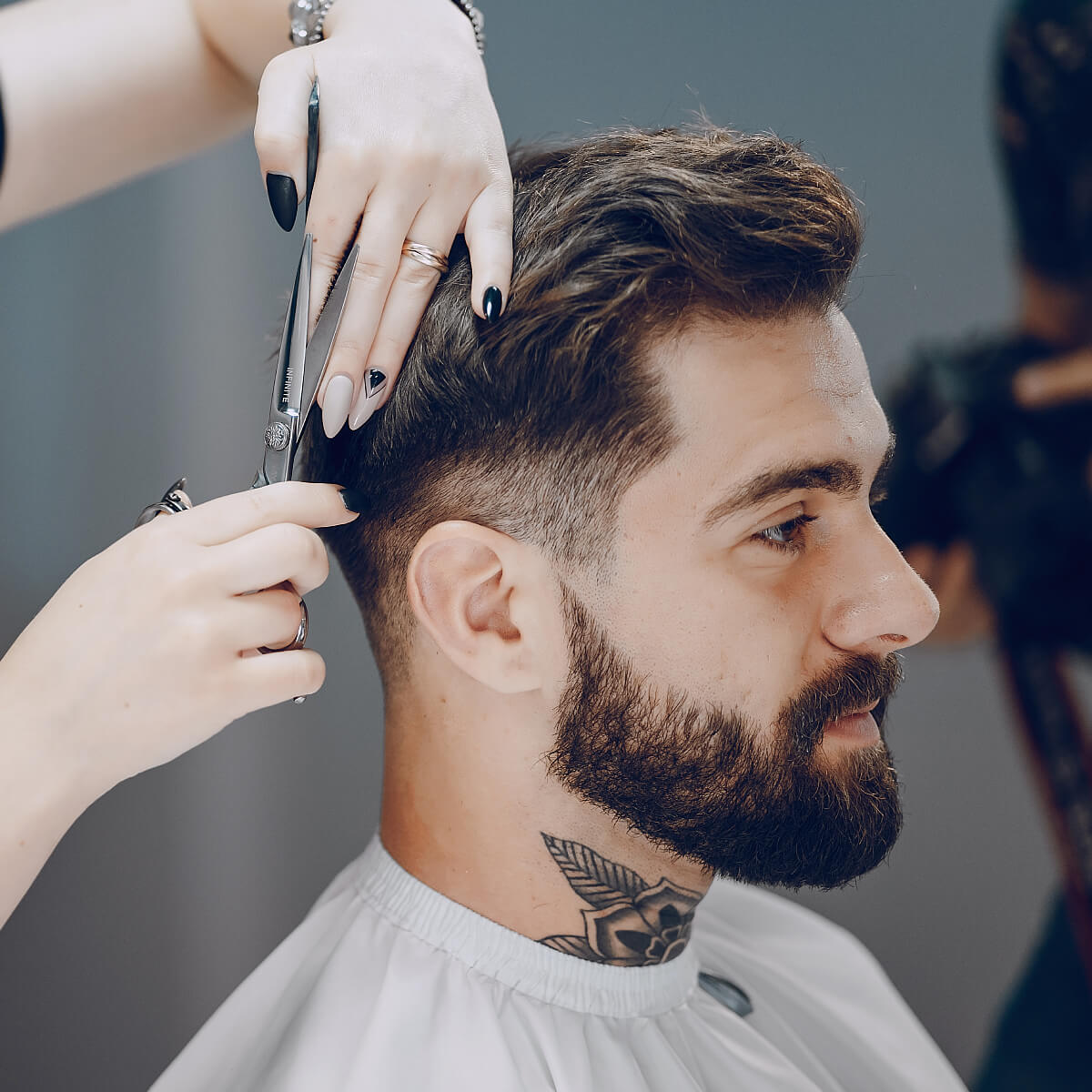Barber giving a precision clipper haircut at Joni's Gentleman's Cuts in Lone Tree